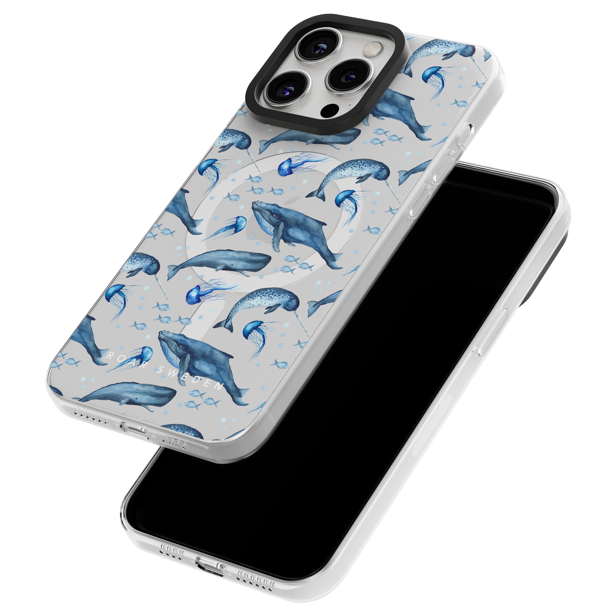 Two smartphone cases from the Ocean-kollektion feature a stunning whale pattern; one case is displayed standing, showcasing the back design, while the other lies flat, revealing the black screen area. These Cetacea - MagSafe Cases perfectly capture undervattensvärldens skönhet.