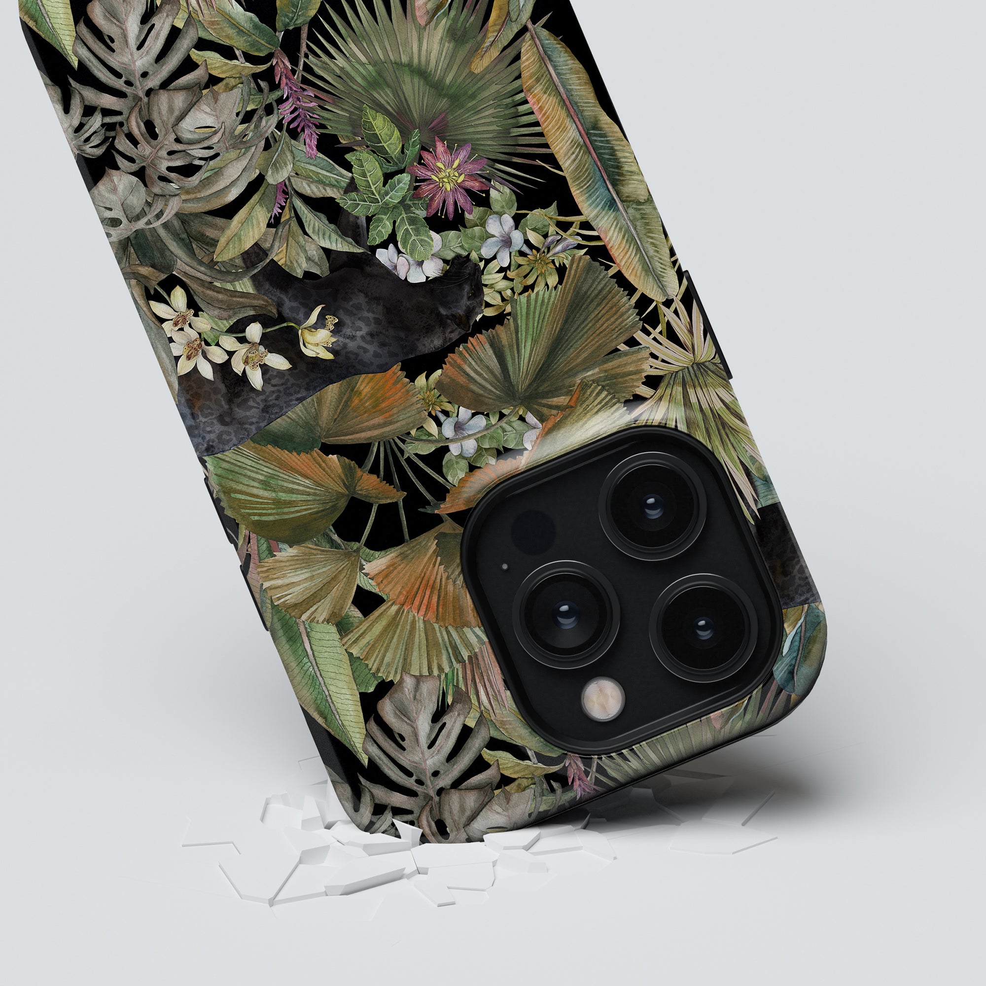 A Bagheera - Tough Case adorned with a vibrant assortment of tropical leaves and flowers.