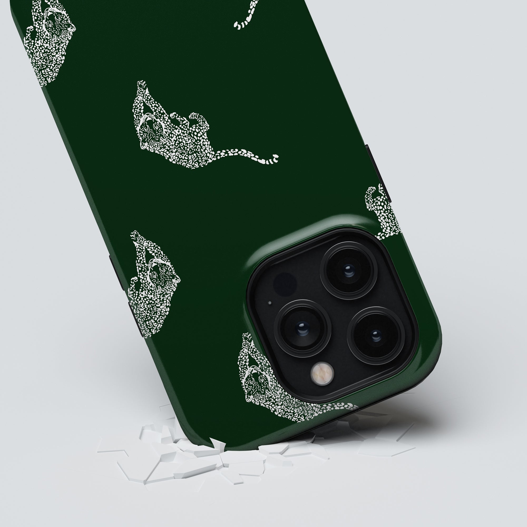 From the Kitty Collection, the Kitty Emerald - Tough Case is a durable green phone case adorned with a white abstract design, elegantly positioned over a cracked surface.