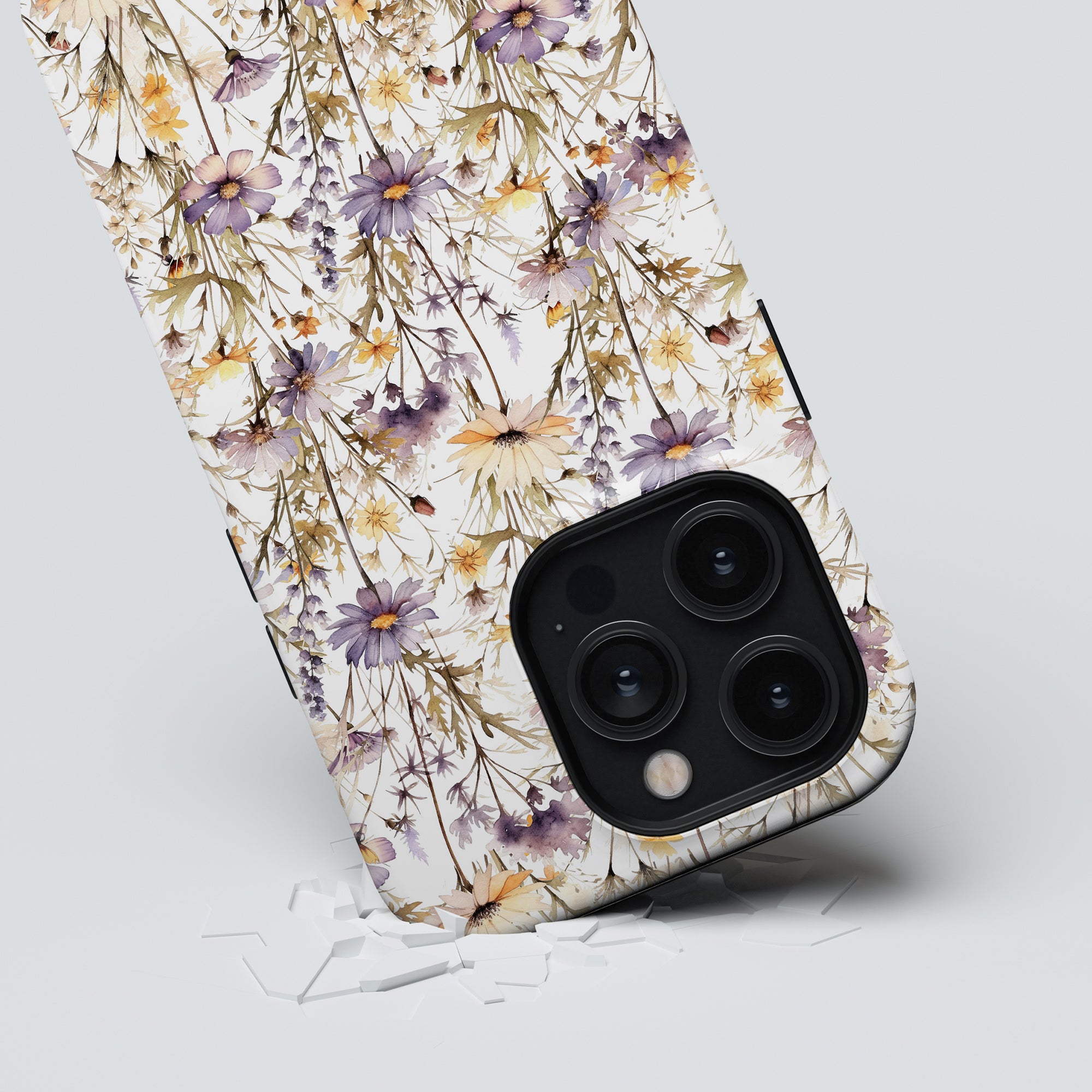 A smartphone with a Purple Wildflower - Tough Case rests on a surface, next to a few scattered white pieces.