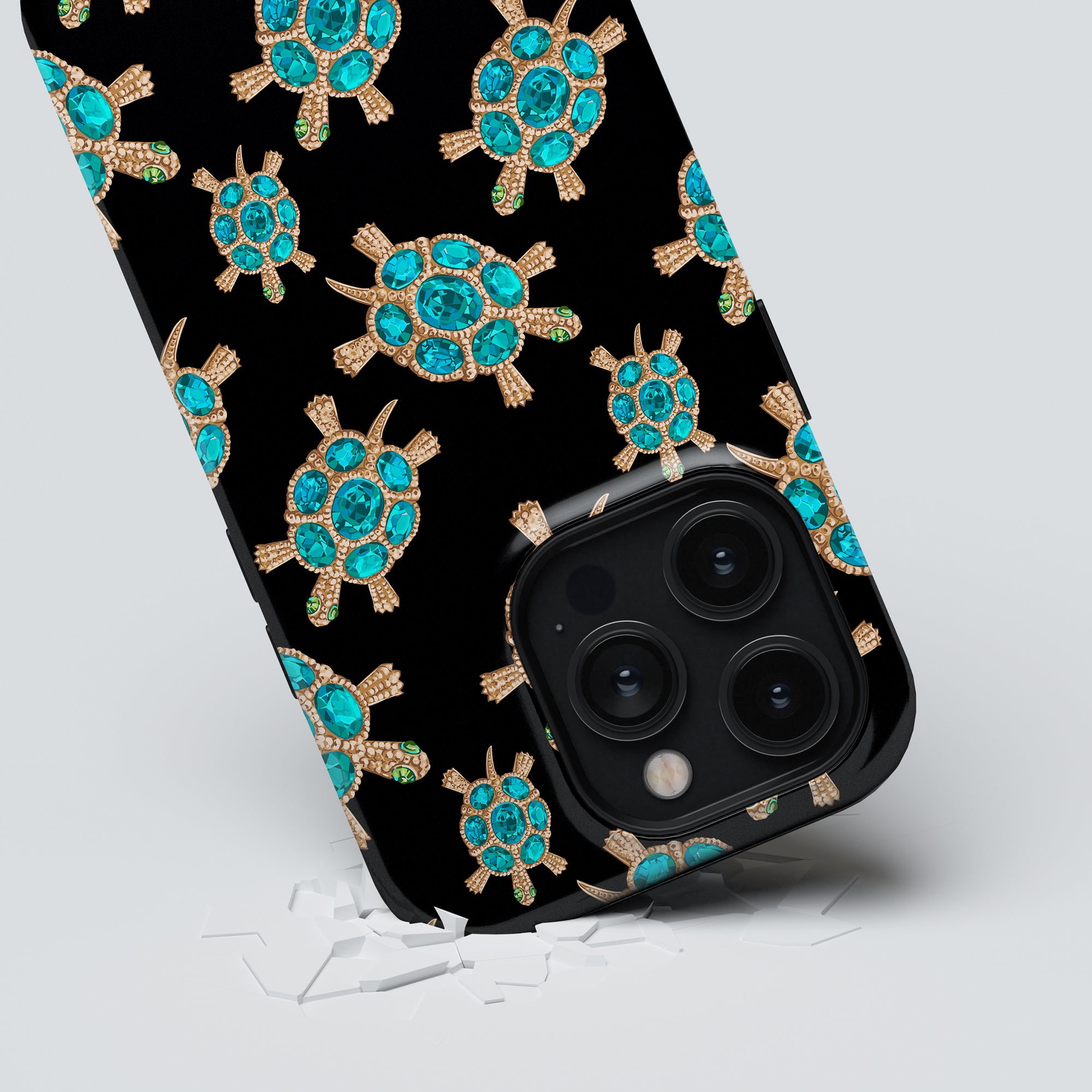 A smartphone with a triple-camera system crashing through a surface with a Diamond Turtle - Tough Case design.