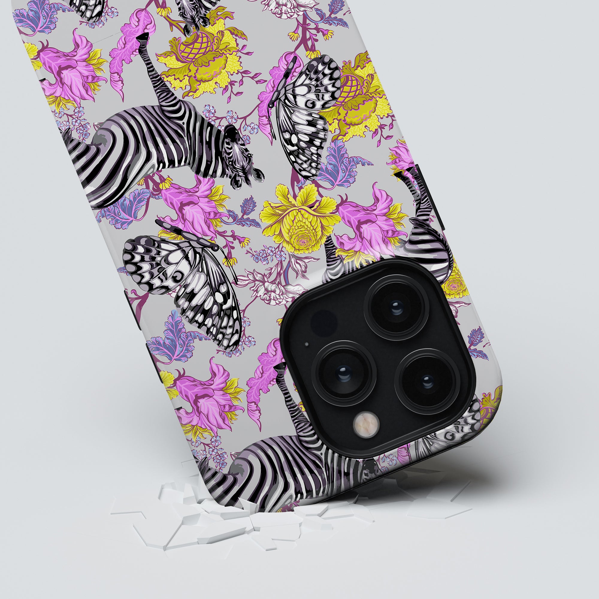 A smartphone with an Exotic Zebra - Tough Case lying face down, its camera breaking through the surface.
