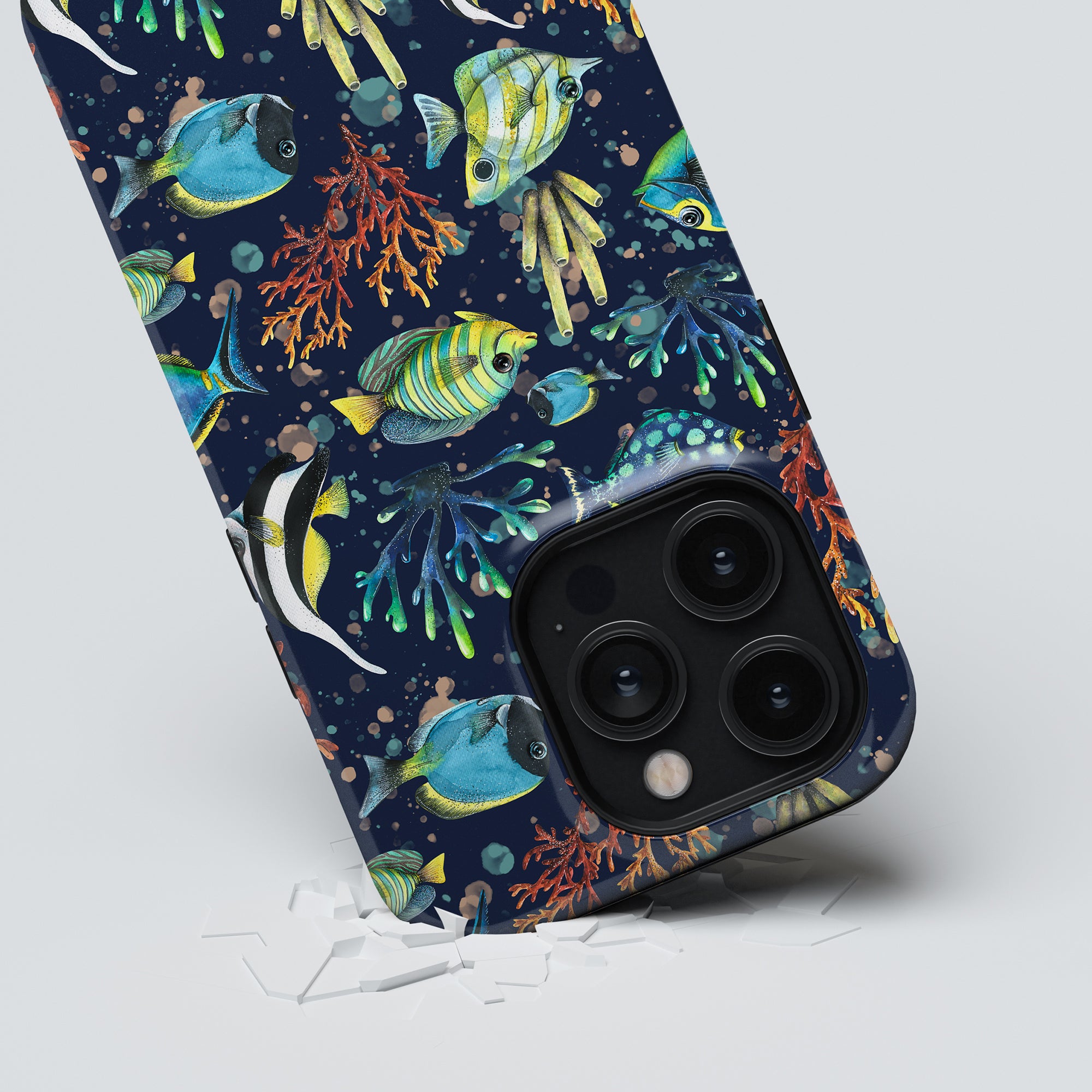 A smartphone with a Tropical Fish-themed tough case displaying a broken screen.