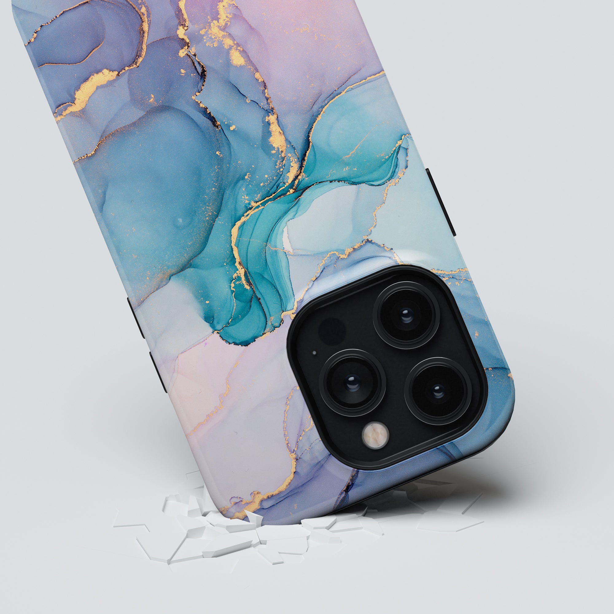 A smartphone with a unique design and a blue and pink marbled Swirl - Tough case lies on a cracked, white surface.