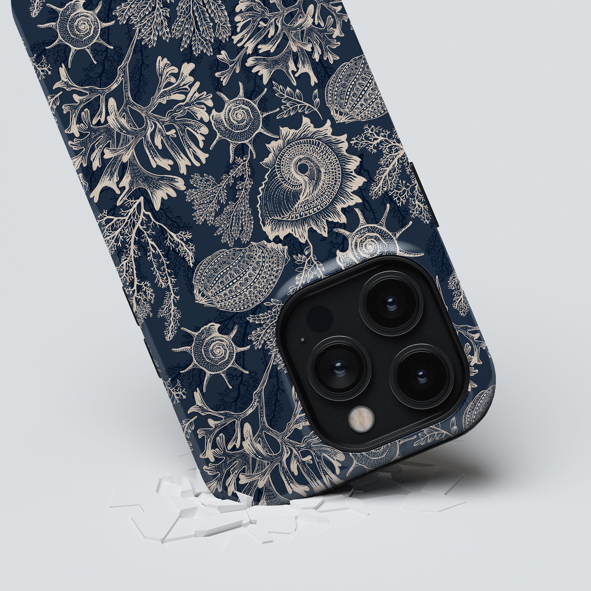 Blue Corals - Tough Case smartphone partially submerged in a white surface, featuring a prominent camera module with three lenses.