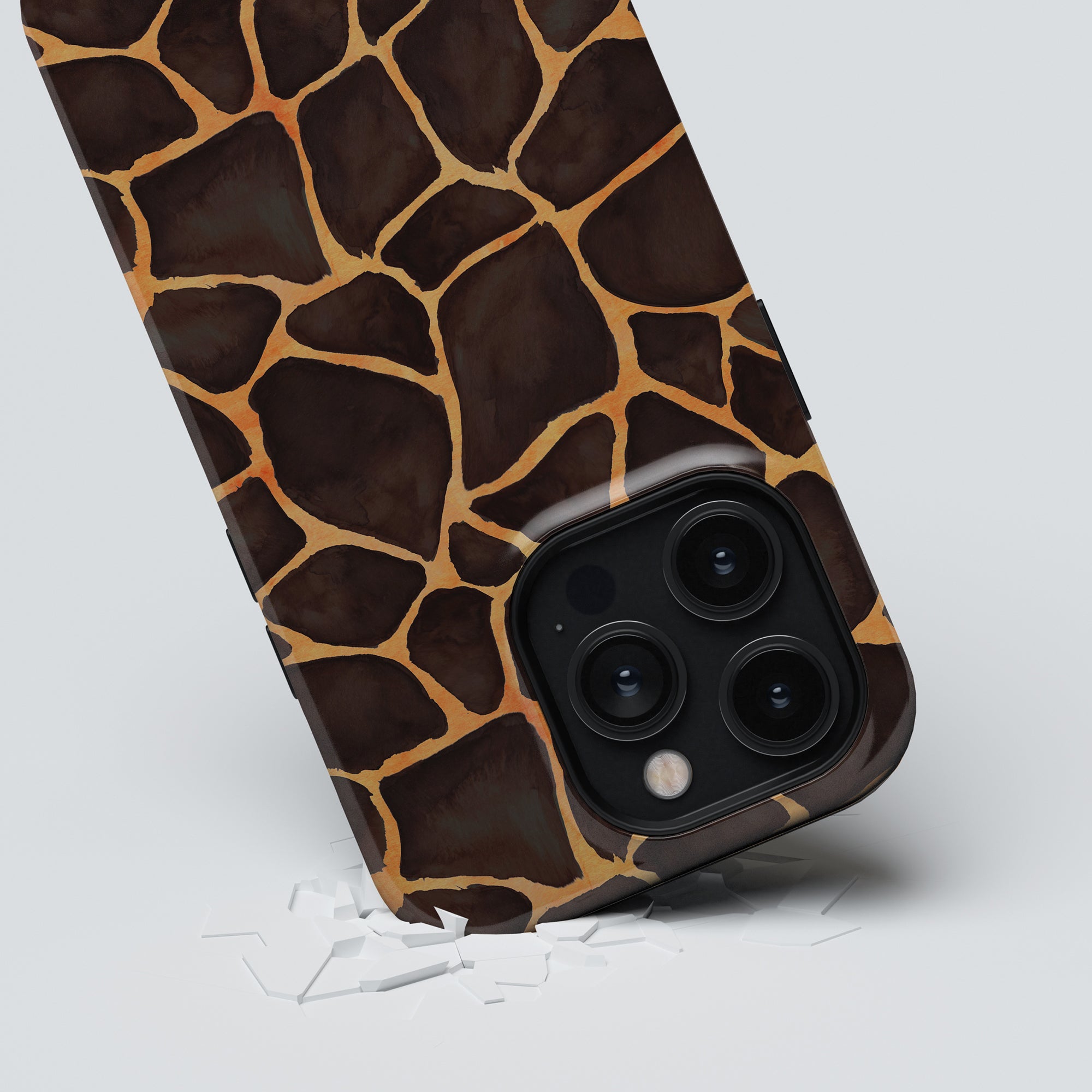 A smartphone with a Giraffe - Tough Case breaking through a white surface, showcasing its triple-lens camera.