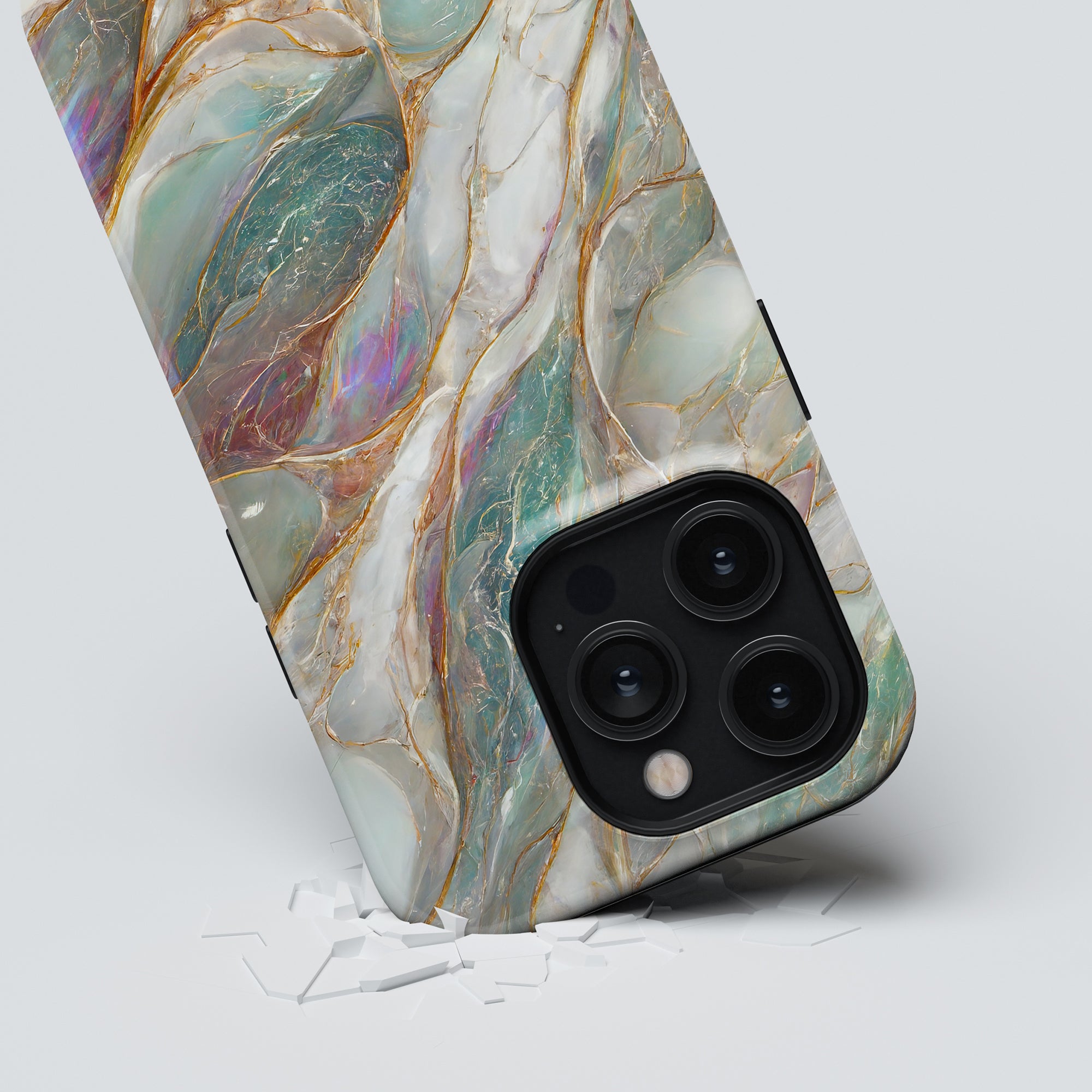 A smartphone with a Mother of Pearl - Tough Case lying on a cracked white surface.