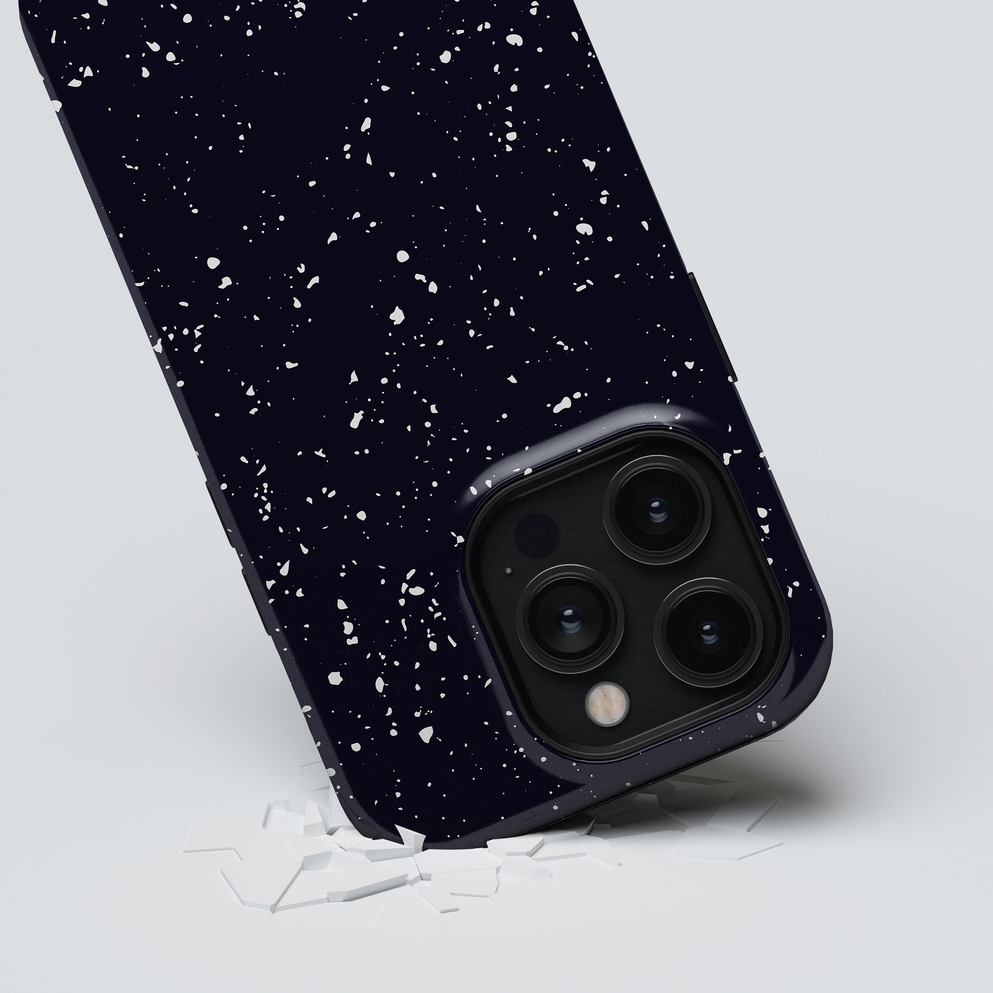 Smartphone with a navy blue back cover adorned with Night Stars - Tough Case, shattering the surface beneath with its impact.
