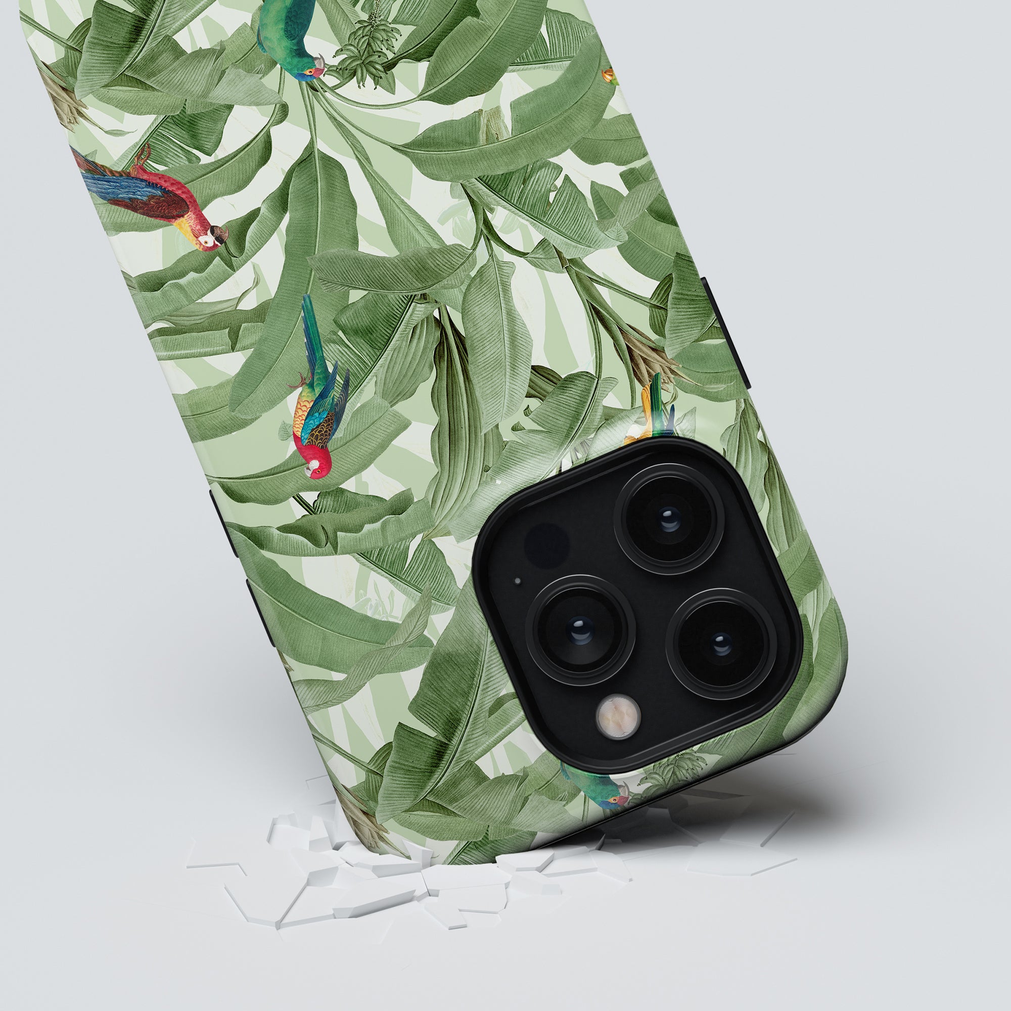 Smartphone with a Parrot Paradise - Tough Case and triple-lens camera breaking through a surface.
