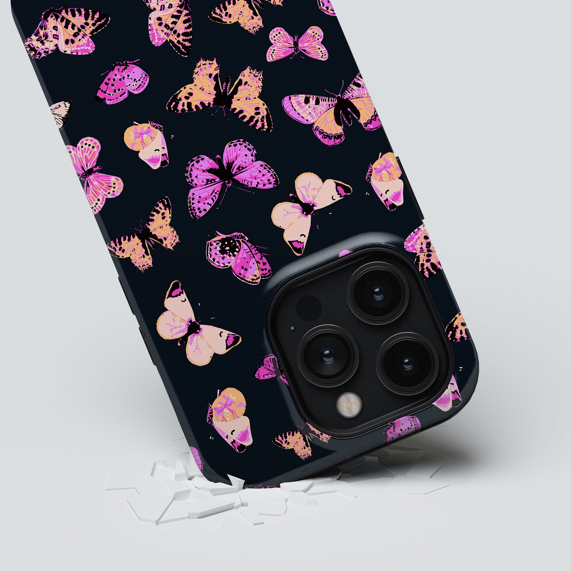 A smartphone with a Pink Butterflies Tough Case from the sommar collection lying face down showcasing its camera module.