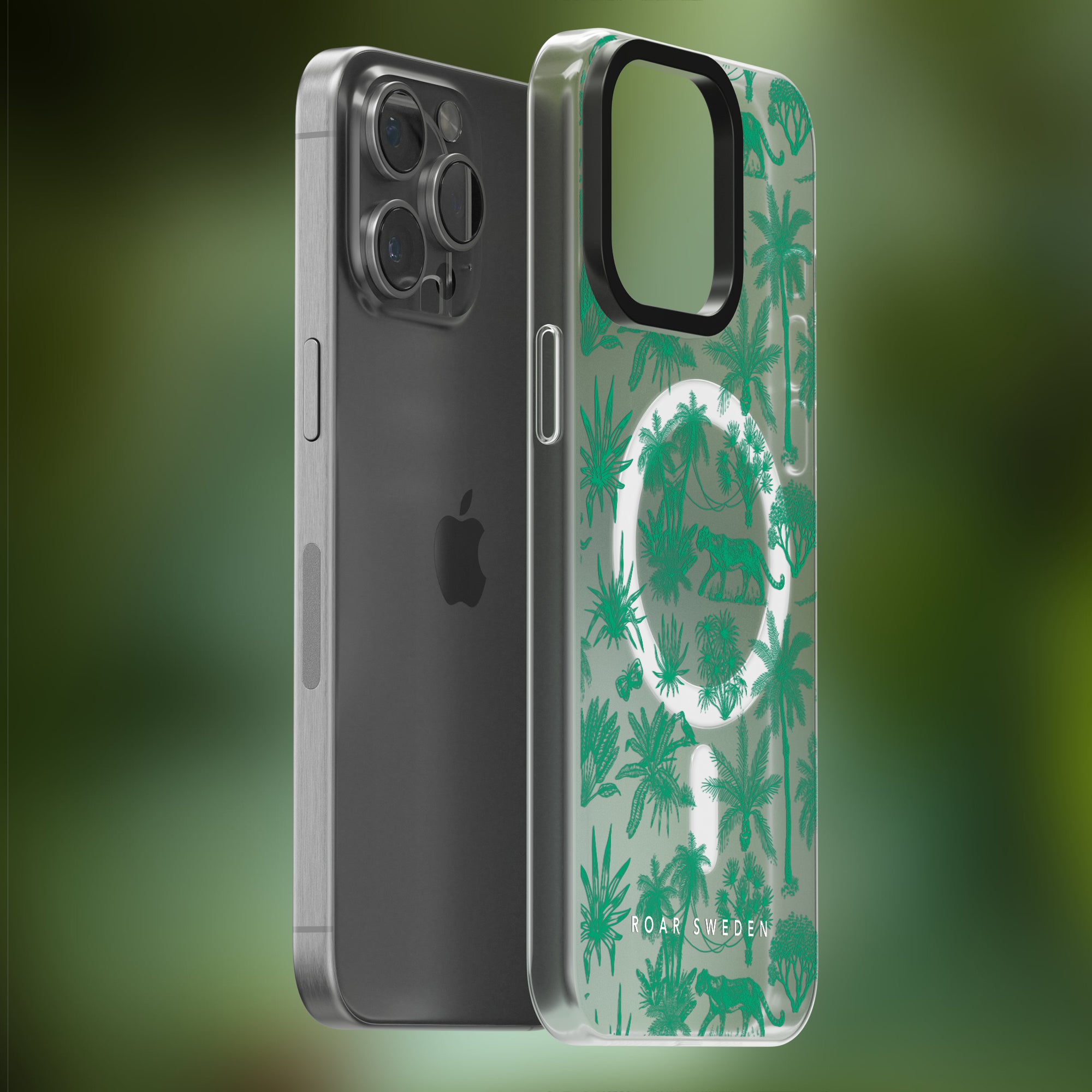 Image shows a sleek smartphone with a gray back next to a Toile De Jouy Mint - MagSafe case adorned with a green jungle pattern and illustrations of animals. The phone case is propped to reveal the back design and the brand "Roar Sweden.